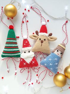 crocheted christmas ornaments are displayed on a table