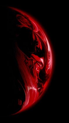 an abstract red and black background with swirls in the center on a dark surface