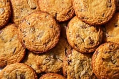 chocolate chip cookies are piled on top of each other in this close up shot,