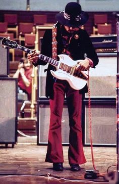 a man playing an electric guitar on stage