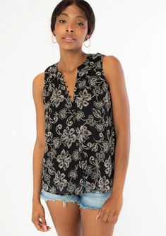 Floral print Chiffon Relaxed fit Sleeveless Hip length Button-loop trimmed v-neckline Self-covered button front Sheer Lined Classic bohemian blouse Chic Floral Print V-neck Tank Top, Chic Black Floral Print Tank Top, Elegant Floral Print Top With Split Neck, Elegant Floral Print Split Neck Top, Bohemian Sleeveless Blouse With Floral Print, Black Sleeveless Blouse With Floral Print, Chic V-neck Floral Print Tank Top, Black Rayon V-neck Blouse, Black Sleeveless Bohemian Blouse