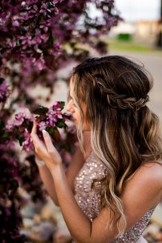 a woman in a dress is holding flowers