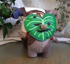 a stuffed animal with a green mask on it's face