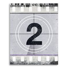 the number two on a film strip with an image of a camera in the middle