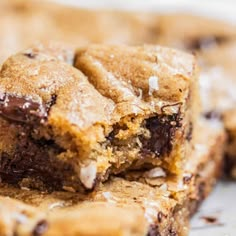 chocolate chip cookie bars stacked on top of each other with bite taken out of one