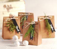 three brown paper bags tied with twine and some white balls on the floor next to them