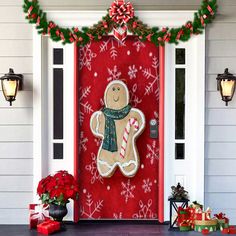 a gingerbread door decorated with christmas decorations and candy canes on the front porch