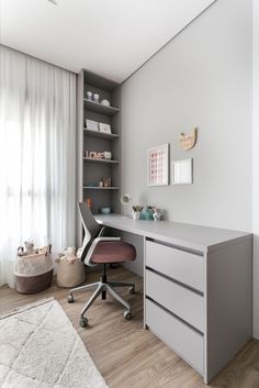 a room with a desk, chair and bookshelf on the wall in it