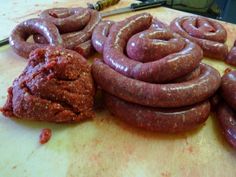 some sausages are laying on a cutting board