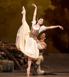 two ballerinas are performing on stage together