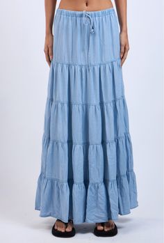 The Denim Days Maxi Skirt features a lightweight denim fabric and tiered ruffle design. Perfect for year-round wear and has an drawstring waistband for all-day comfort Material & Care: Made from 100% Tencel. For best care, machine wash cold with like colors on a gentle cycle. Use a mild detergent. Avoid bleach. Hang to dry. Iron on low heat if needed Size & Fit: Model is 5'8" wearing size small Bust: 34B Waist: 24 Hips: 34 Cotton Drawstring Tiered Skirt, Cotton Tiered Skirt With Drawstring, Summer Cotton Denim Skirt With Ruffles, Blue Drawstring Skirt For Spring, Blue Tiered Bottoms With Ruffle Hem, Spring Blue Drawstring Skirt, Denim Blue Ruffled Cotton Skirt, Denim Blue Cotton Ruffled Skirt, Denim Blue Tiered Cotton Skirt