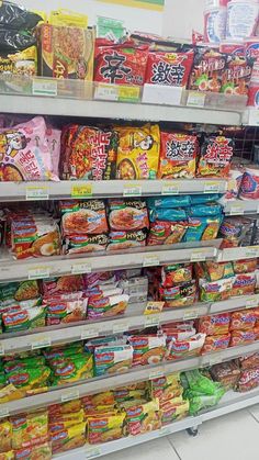 a display in a store filled with lots of snacks and food items on it's shelves