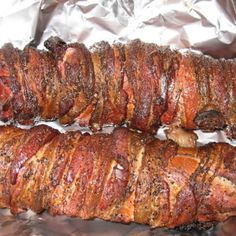 two pieces of meat sitting on top of aluminum foil