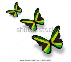 three butterflies with the flag of jamaica on their wings, flying in opposite directions to each other