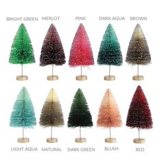 twelve small christmas trees in different colors and sizes on wooden bases, each decorated with colored feathers