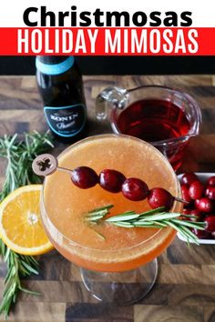 a holiday mimosa is garnished with cranberries and rosemary