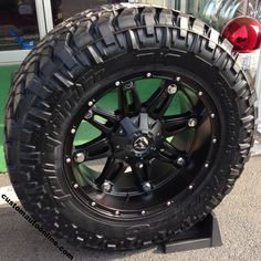 a black truck tire on display in front of a building