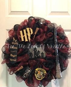 a harry potter wreath with hogwarts and wands hanging on the front door