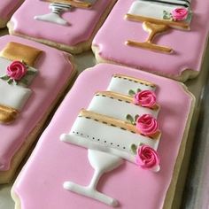 decorated cookies are arranged in the shape of wine glasses and bottles with roses on them