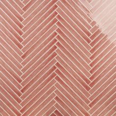 a close up view of an orange and pink herringbone pattern tile wallpaper background