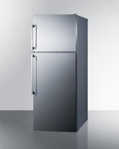 a silver refrigerator freezer sitting on top of a counter next to a white wall