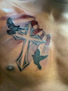 a man with a cross tattoo on his chest