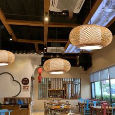 a restaurant with wooden tables and blue chairs