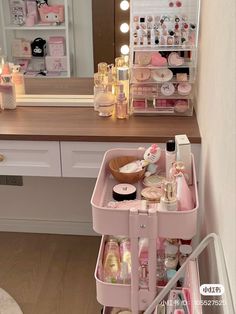 the vanity is filled with makeup and personal care items in pink containers, along with other beauty products