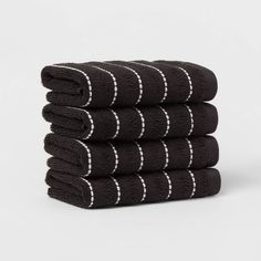 five black towels stacked on top of each other