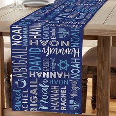 a blue table runner with white lettering on it and a wooden dining room table in the background