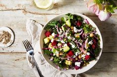 a white bowl filled with salad on top of a wooden table