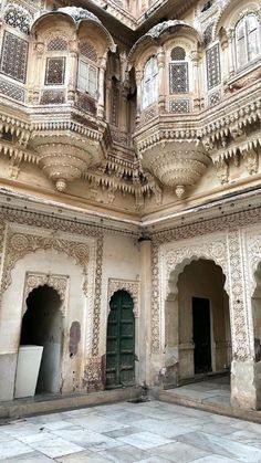 an old building with intricately carved walls and arches on the ceiling, in india