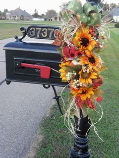 the mailbox is decorated with sunflowers and other flowers