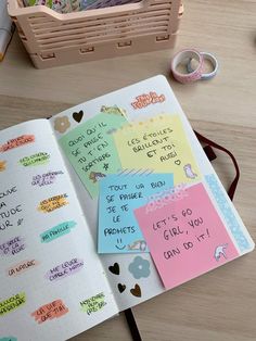 an open notebook with sticky notes on it