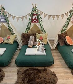 three beds with pillows and blankets on them in front of a wall decorated with christmas decorations