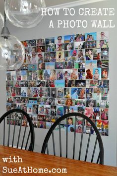 a dining room table with two chairs and a wall covered in pictures on the wall