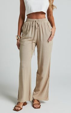 Get ready to elevate your pants game with our Kala Pants in Sand! These mid-waisted, relaxed elastic waist pants are perfect for adding a touch of casual chic to any outfit. Made from soft and breathable cotton, these full-length pants will keep you comfortable all day long. Whether you're going for a laid-back look or dressing up for a party, the neutral color of these pants makes them incredibly versatile. Embrace your individuality and showcase your style with our empowering Kala Pants! Produ Beige High-waisted Pull-on Pants, Comfortable Straight Leg Bottoms With Elastic Waistband, Beige Pull-on High-waisted Pants, Solid Color Pants With Elastic Waistband For Lounging, Effortless Cotton Bottoms For Day Out, Effortless Summer Loungewear Pants, Relaxed Fit Pants For Summer Lounging, Relaxed Fit Pants For Lounging In Summer, Comfortable High-waisted Summer Pants