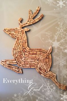 a christmas card with a deer made out of wine corks