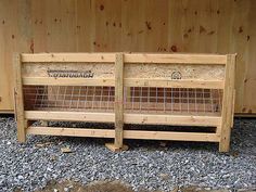 two wooden benches sitting next to each other on top of gravel and wood planks