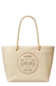 A signature logo appliqué stands out front and center on a spacious tote fashioned with a crinkled exterior and convertible chain straps for modern appeal. Top carry handles Interior zip pocket Lined Coated cotton with synthetic trim Imported Tory Burch Ella, Fabric Gift Bags, Fabric Gifts, Free Fabric, Anniversary Sale, Signature Logo, Print Gifts, Chain Strap, Leather Tote