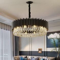 a living room filled with furniture and a chandelier hanging over the top of it