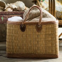 a wicker basket sitting on top of a wooden floor