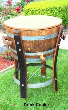 a wooden barrel table sitting in the grass