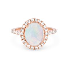 Timeless and romantic, this ring features a 1.70 carat oval cut opal accented by a halo of round brilliant cut diamonds totaling 0.60 carats. Luxury Oval Opal Ring With Halo Setting, Classic Oval Opal Ring With Halo, White Opal Ring With Oval Halo Setting, White Oval Opal Ring With Halo Setting, Formal Oval Opal Ring With Halo Design, Elegant Oval Opal Ring With Halo, Elegant Oval Opal Halo Ring, Oval Opal Ring With Halo Setting, Elegant Oval Halo Opal Ring