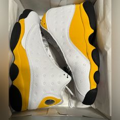 The Air Jordan 13 Retro Del Sol Is A Colorway Of The Iconic Air Jordan 13 Worn By Mj Throughout Most Of The 1998 Postseason. This Sneaker Is Dressed In A White, Del Sol, University Red, And Black Color Scheme. The Hits Of Yellow Are On The Suede Overlays, While Hits Of White Are Visible On The Shoe’s Panels, Toe, And Tongues. The Red Is On The Jumpman Logo Embroidered On The Tongue, While The Black Is Visible On The Shoe’s Rubber Outsole. . Yellow Perforated Sneakers For Streetwear, Yellow Sneakers With Perforations And Round Toe, Yellow Sporty Sneakers With Perforations, Sporty Yellow Sneakers With Perforations, Yellow Leather Sneakers With Perforations, Sporty Yellow Jordan Lace-up Shoes, High-top Yellow Basketball Shoes For Light Sports, Yellow Synthetic Basketball Shoes For Light Sports, Yellow High-top Synthetic Jordan Shoes