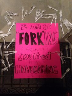 a pink sign that reads forking is surrounded by plastic forks and paper clippings