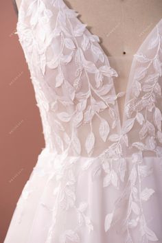 the back of a wedding dress with flowers on it