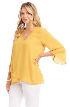 An elegant top of silky, lightweight crepe delivers elegant movement with its angled flare sleeves and fluttery asymmetrical hemline that dips low in back. 25 1/2" length (size Medium) V-neck Three-quarter sleeves Back yoke with gathering Crossover high/low hem 100% polyester Dry clean or hand wash, line dry Made in the USA of imported fabric Women's Clothing Elegant Spring Blouse With Asymmetrical Hem, Elegant Stretch Top With Asymmetrical Hem, Elegant Stretch Tops With Flutter Sleeves, Elegant Stretch Tops With Asymmetrical Hem, Elegant Asymmetrical Blouse With Draped Sleeves, Spring Formal Top With Asymmetrical Hem, Formal Spring Top With Asymmetrical Hem, Elegant Blouse With Draped Asymmetrical Sleeves, Formal Tops With Asymmetrical Hem For Spring