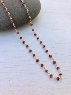 Garnet Necklace, Garnet Beaded Necklace, January Birthstone, Dainty Garnet Necklace, Red Choker Necklace, Simple Gold Necklace, Gift for her Beaded red garnet rosary style necklace wire wrapped in 14k gold filled or sterling silver. Rondelles are 3mm in size. Necklace closes with lobster clasp in the finish of your choice. About This Necklace: - Stone: Garnet - Birthstone Month: January - Garnet Properties: Friendship, Love and Guidance - Stone Size: 3mm - Necklace Length: Choice of 16 or 18 inc Garnet Necklaces With Faceted Beads For Gifts, Faceted Beads Chain Necklace As Gift, Gift Chain Necklace With Faceted Beads, Gift Faceted Beads Chain Necklace, Dainty Red Beaded Necklaces With Round Beads, Dainty Red Beaded Necklace With Round Beads, Red Ruby Gemstone Bead Necklaces, Red Garnet Beaded Necklaces With Round Beads, Red Ruby Gemstone Beads Necklaces