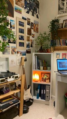 a room filled with lots of clutter and pictures on the wall next to a laptop computer